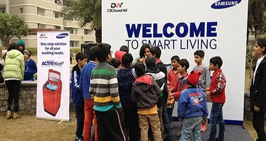 Group of children and adults participating in apartment activities outdoors