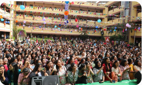 Large crowd of college students gathered inside a mall atrium for activation