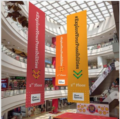 Vertical mall branding banners hanging inside a mall