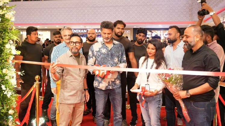 People cutting ribbon at a store launch event